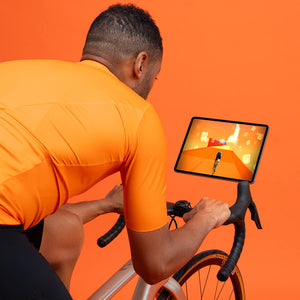 Man climbing a hill on Zwift app with smart resistance